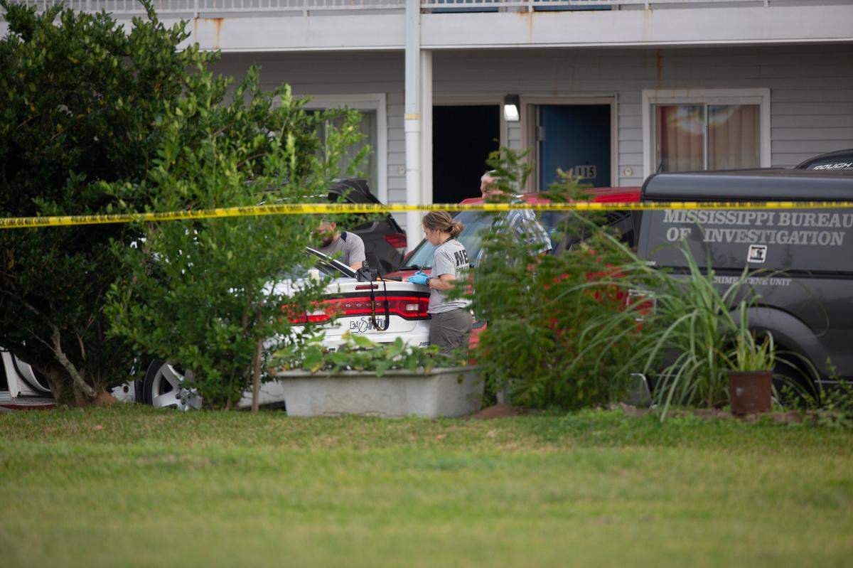 The Mississippi Bureau of Investigation examines a Bay St. Louis police car outside of Motel 6 on Highway 90 on Wednesday, Dec. 14, 2022. Two Bay police officers were shot and killed while responding to a call there.