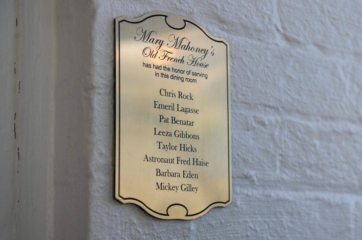 Plaques hang near the doorways of each dining room inside Mary Mahoney’s listing the celebrities who have dined in that room. One of the plaques listing celebrities like Emeril Lagasse hangs in the restaurant on Friday, Jan. 27, 2023.
