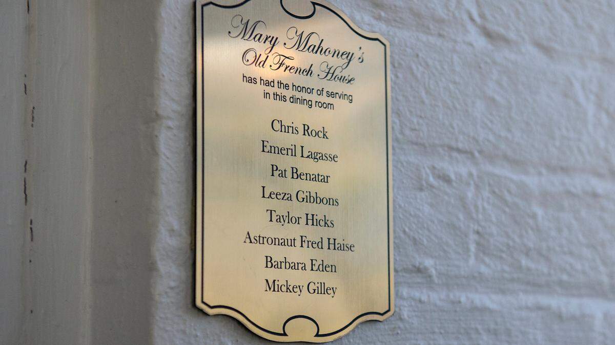 Plaques hang near the doorways of each dining room inside Mary Mahoney’s listing the celebrities who have dined in that room.