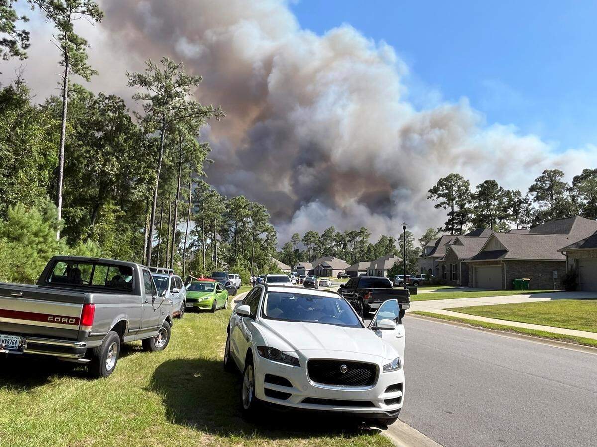 Smoke is seen rising above the Talla Pointe subdivision in St. Martin on Thursday, Aug. 8, 2024, as a woods fire burns nearby.