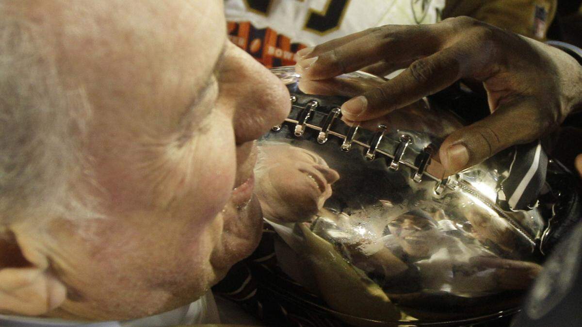 New Orleans Saints owner Tom Benson takes the Vince Lombardi Trophy after the NFL Super Bowl XLIV football game against the Indianapolis Colts in Miami, Sunday, Feb. 7, 2010. The Saints won 31-17. (AP Photo/David J. Phillip)