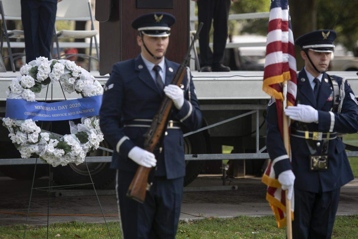 Members of the Keesler Air Force Base Honor Guard present the colors during a Memorial Day ceremony at Biloxi National Cemetery in Biloxi on Monday, May 26, 2025.