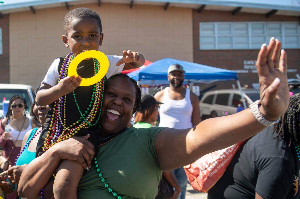 Parade attendees try to catch beads during the Jackson County Carnival Association Mardi Gras parade in Pascagoula on Saturday, March 1, 2025.