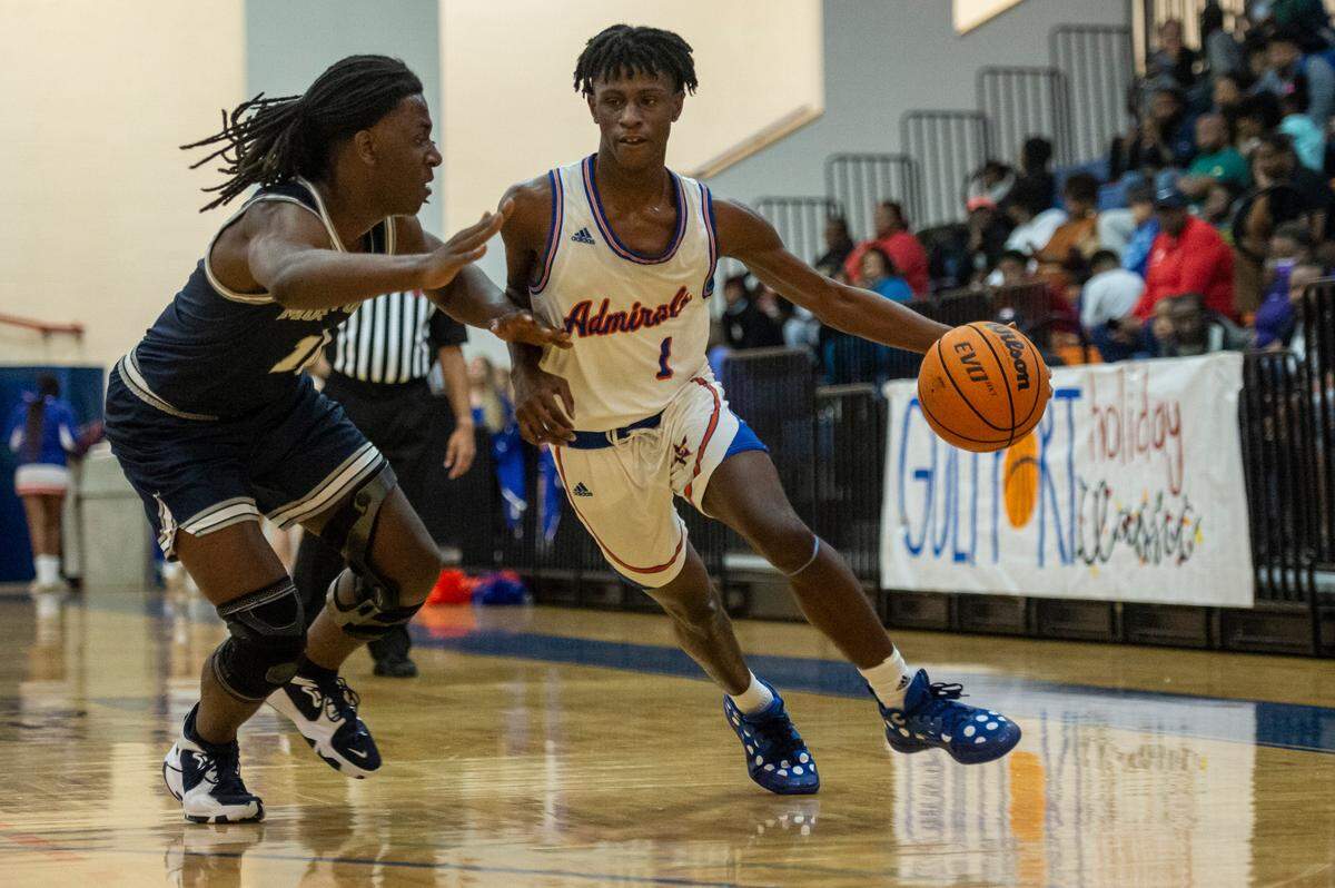 Gulfport’s Kamari Mitchell, right, dribbles the ball down the court during a matchup with Moss Point during the Adidas Holiday Classic at Gulfport High School in Gulfport on Tuesday, Dec. 28, 2021.