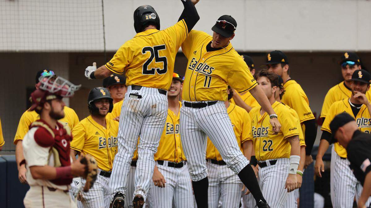 Southern Miss catcher Blake Johnson (25) scores and celebrates with pitcher Aubrey Gillentine (11) during an NCAA Baseball Oxford Regional game between Southern Miss and Florida State at Swayze Field, Oxford, MS, Sunday, June 6, 2021.