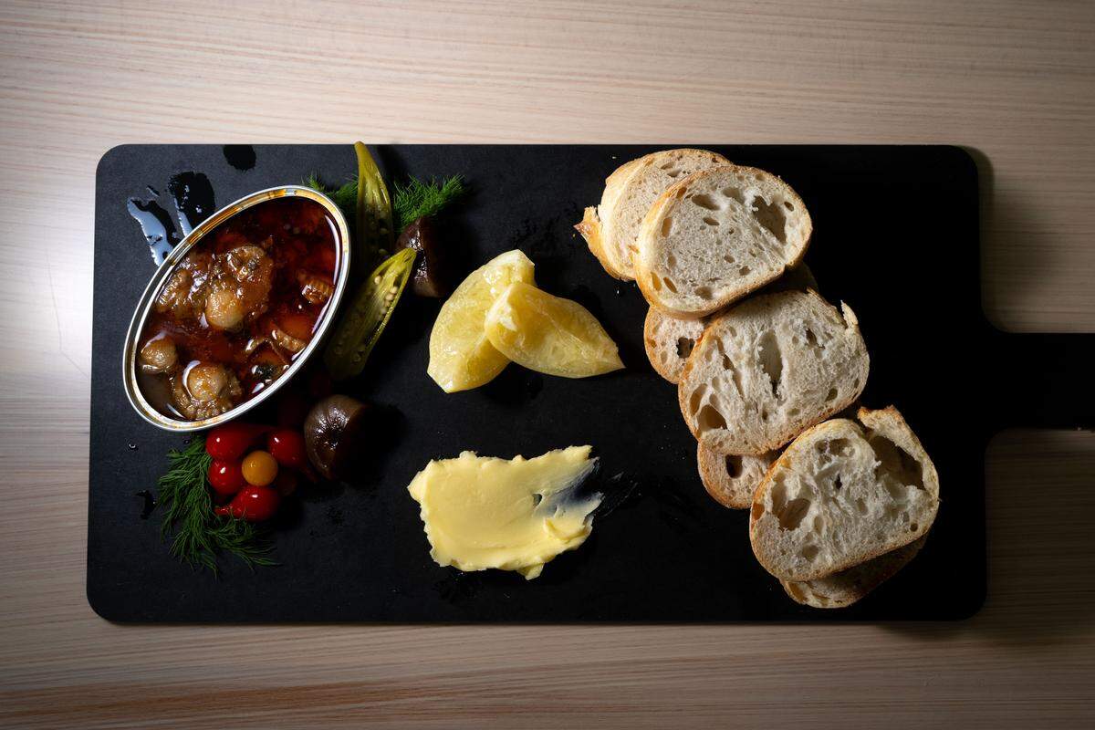 The Tin of the Week featuring a mix of scallops, cheeses, lemon, pickles, bread and fresh produce at St. James Cheese Company in Pass Christian.