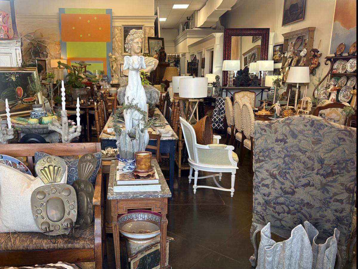 The interior of OS Antiques is pictured from the storefront in a strip shopping center on Bienville Boulevard in Ocean Springs. The small shop is crammed with antiques and interior decor.