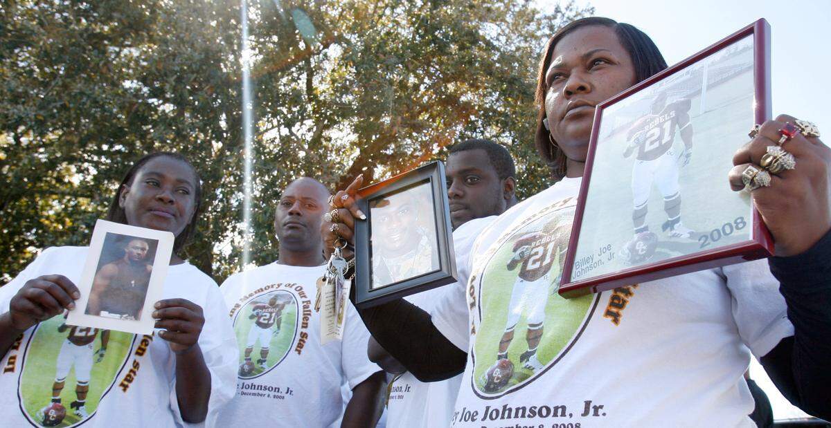 Kima Bradley, right, along other family members of Billey Joe Johnson, jr. display photos of Johnson at the George County Courthouse in 2009 for the Grand Jury findings on the death of Johnson.