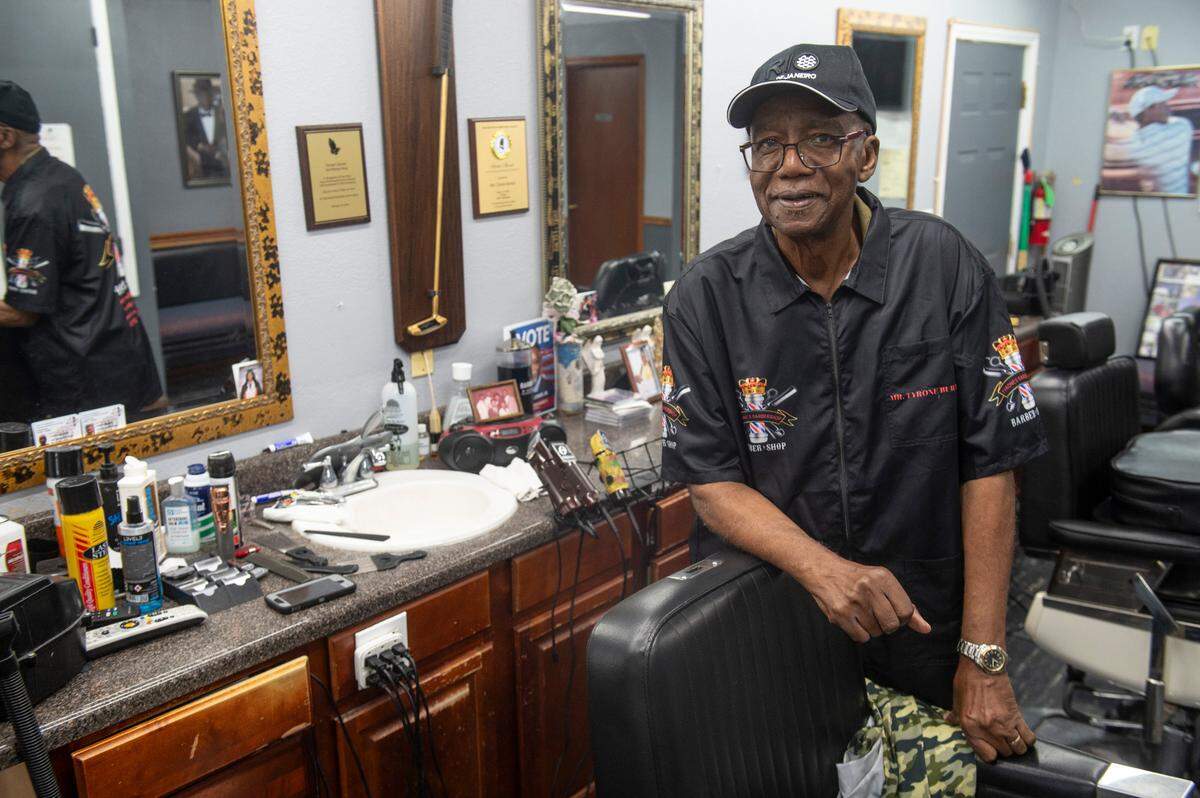 Tyrone Burton, who has been a barber in Biloxi for nearly 64 years, poses in his business Tyrone’s Barber and Beauty Salon in Biloxi on Wednesday, May 21, 2025. Burton will be honored by the city of Biloxi with the renaming of a section of Main Street.