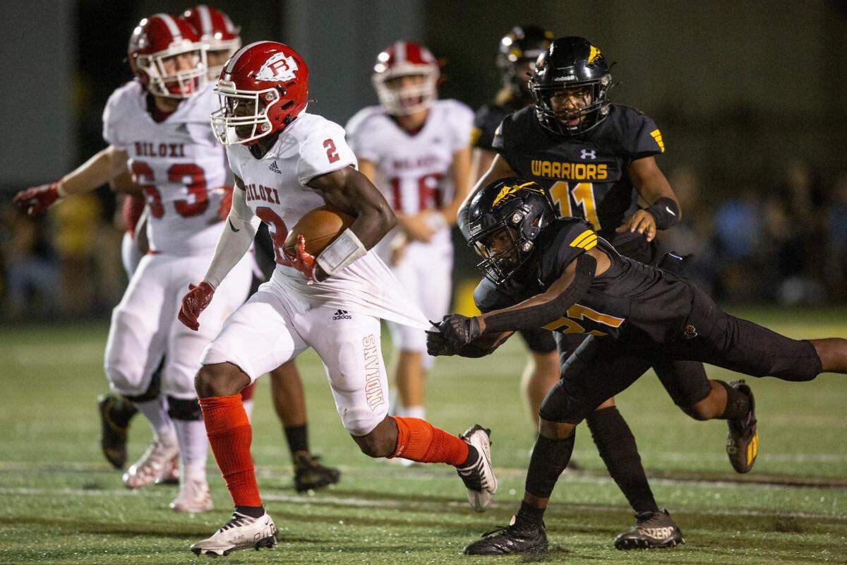 Biloxi’s Damaryion Fillmore breaks away from a tackle to score against D’Iberville during a game at Warriors Stadium in D’Iberville on Friday, Sept. 23, 2022.