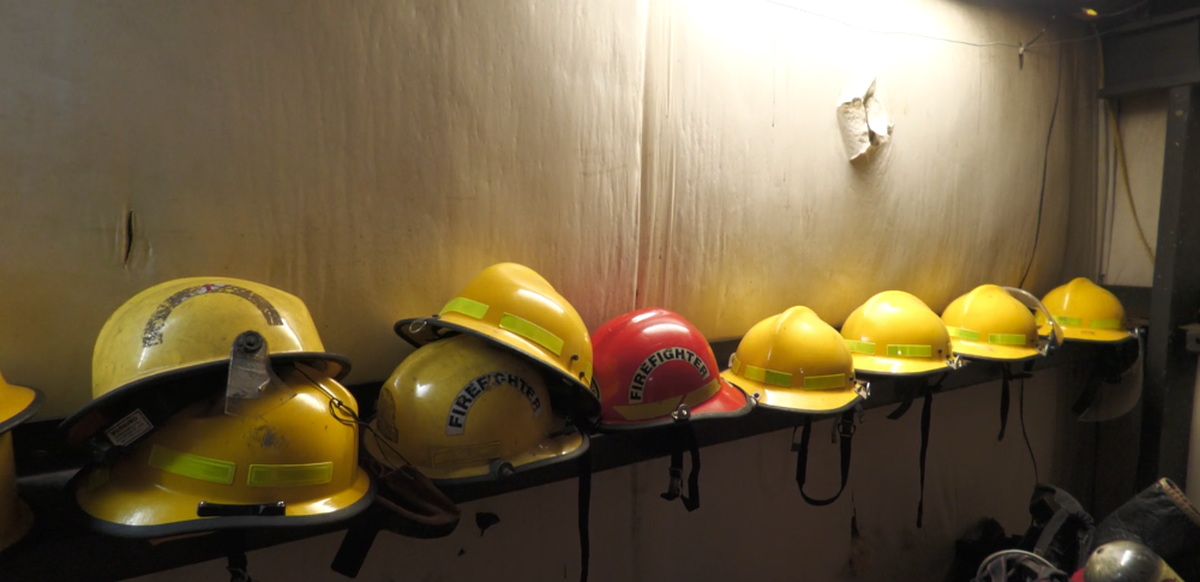 Helmet shells line a shelf in the McHenry-Sunflower Volunteer Fire Department’s equipment room in McHenry, Miss. Several have been stripped for parts to repair other helmets.