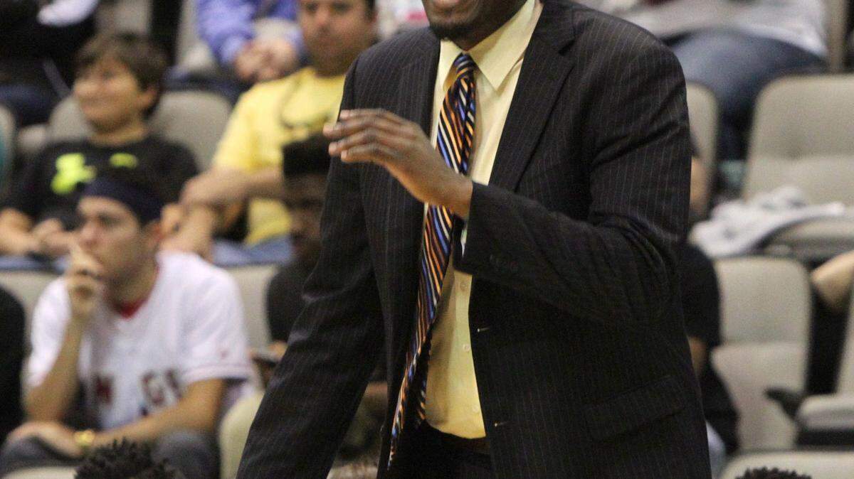 JOHN FITZHUGH/SUN HERALD 
 D'Iberville head coach Lorenzo Wright and the Warriors defeated Ocean Springs 62-34 on Thursday.