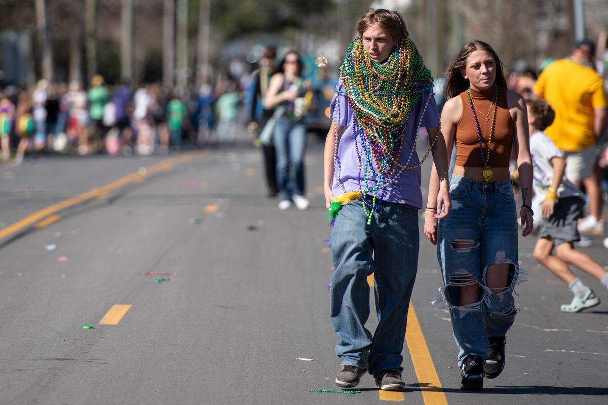 Revelers collect lots of beads during the Jackson County Carnival Association Mardi Gras parade in Pascagoula on Saturday, March 1, 2025.