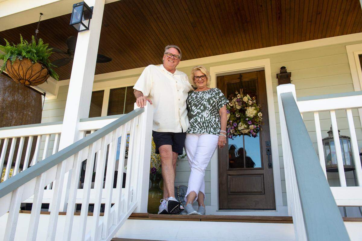 Stephen Dinjar and Sheila Dinjar pose for a photo outside their home in the Timber Ridge subdivision in Pass Christian on Tuesday, March 25, 2025. The Dinjars moved from Dallas two years ago.