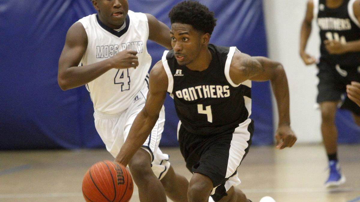 TIM ISBELL/SUN HERALD 
 Pascagoula's Anthony McMillian pushes the ball up court against Moss Point's David Evans, Friday, Dec. 4, 2015.