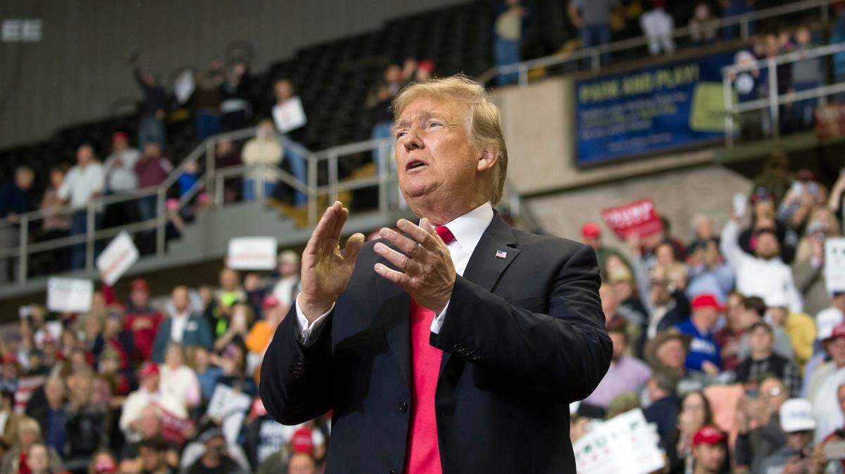 President Donald Trump applauds as he departs a rally for Sen. Cindy Hyde-Smith, R-Miss., at the Mississippi Coast Coliseum, Monday, Nov. 26, 2018, in Biloxi, Miss.