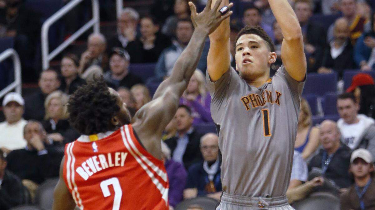 RICK SCUTERI/ASSOCIATED PRESS 
 Phoenix Suns guard Devin Booker (1) shoots over Houston Rockets guard Patrick Beverley on Feb. 4 in Phoenix.