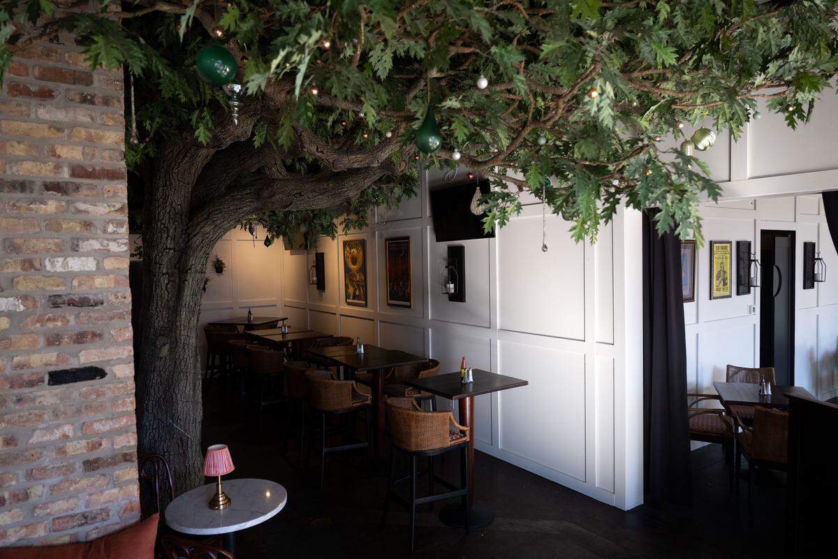 An indoor tree with ornaments hanging from its branches stands at the entrance to Marcello’s Taste of New Orleans on Thursday, Dec. 11, 2025.