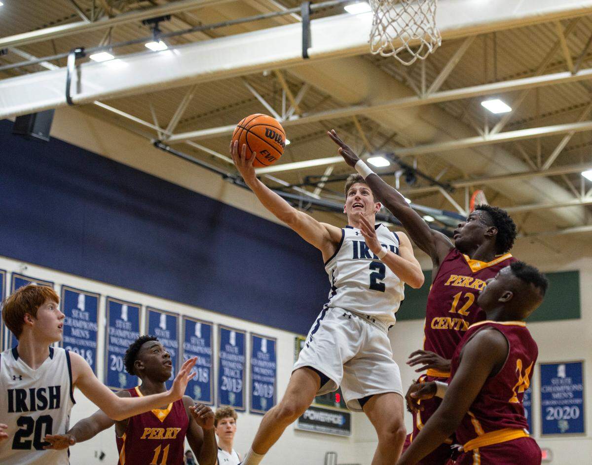 St. Patrick guard Nick Krass (#2) avoids Perry Central’s Cameron Rankins’ (#12) block during a game against Perry Central at St. Patrick Catholic High School on Thursday, Jan. 13, 2022.