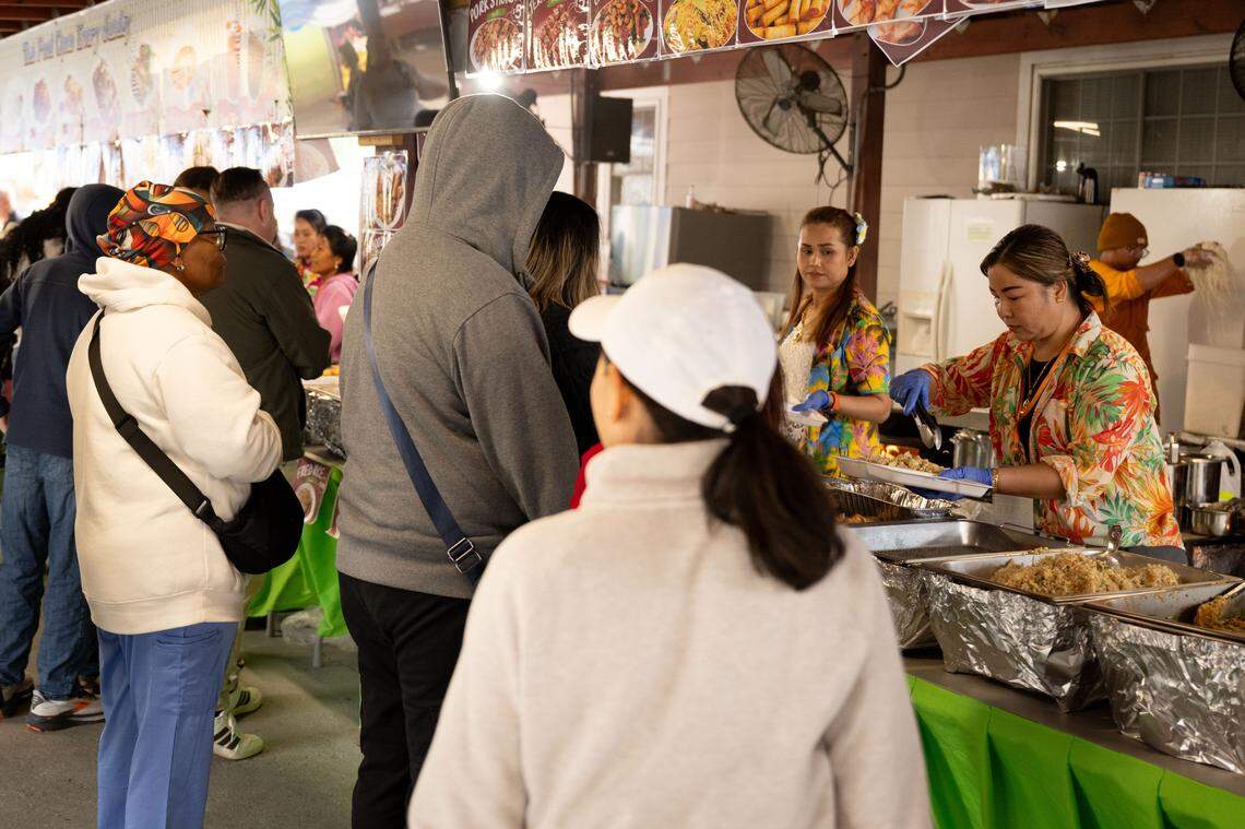Hundreds of people line up for food during Songkran at the Wat Buddhametta Mahabaramee in Gautier on Sunday, April 19, 2026.