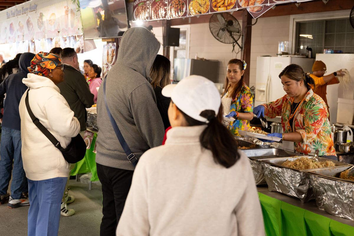 Hundreds of people line up for food during Songkran at the Wat Buddhametta Mahabaramee in Gautier on Sunday, April 19, 2026.