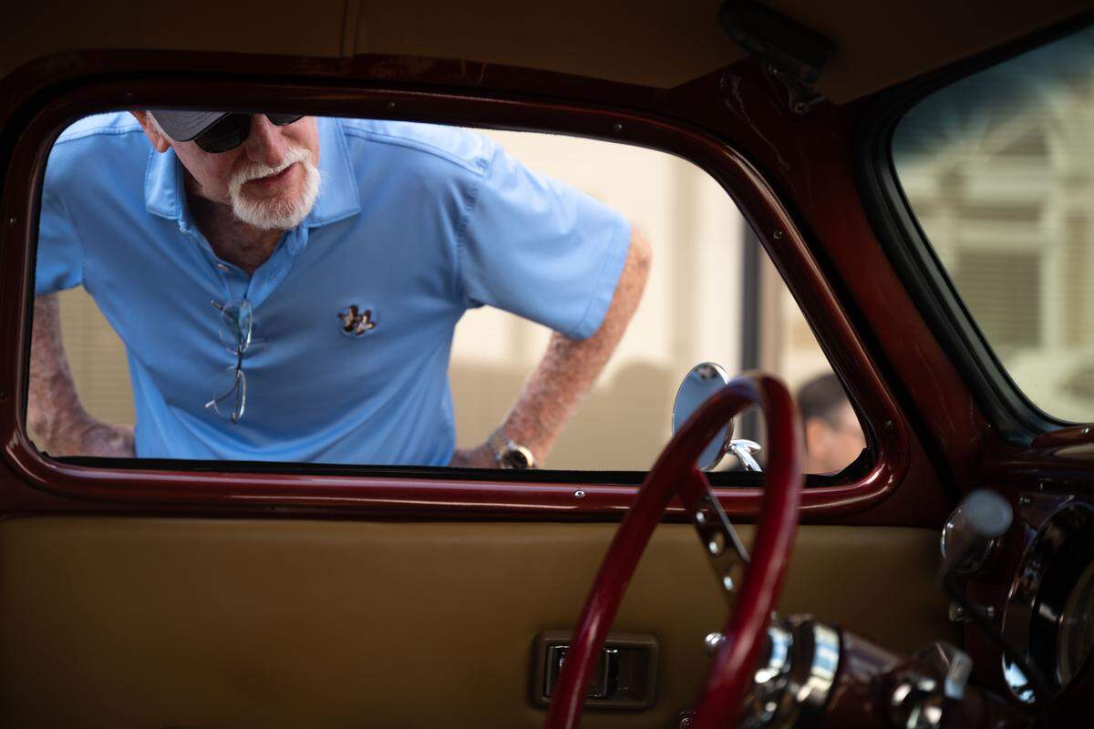 A car buff checks out the interior of one of the cars at the Biloxi Block Party during Cruisin’ The Coast 2025.