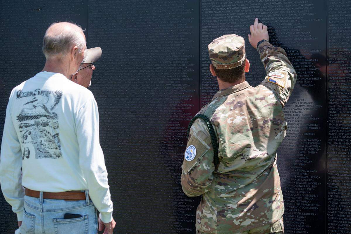 A JROTC member helps visitors find names on The Wall That Heals, a traveling three-quarter scale replica of the Vietnam Veterans Memorial in D.C., while it is on display at the D’Iberville Sports Complex in D’Iberville on Thursday, April 10, 2025.