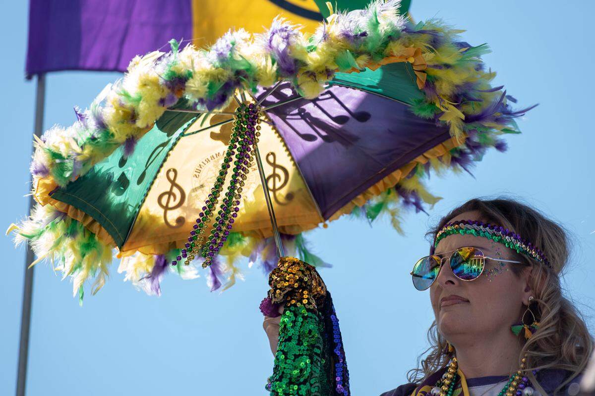 Mardi Gras colors adorn a parade watcher’s outfit during the Gulf Coast Carnival Association Mardi Gras Parade in Biloxi on Tuesday, March 1, 2022.
