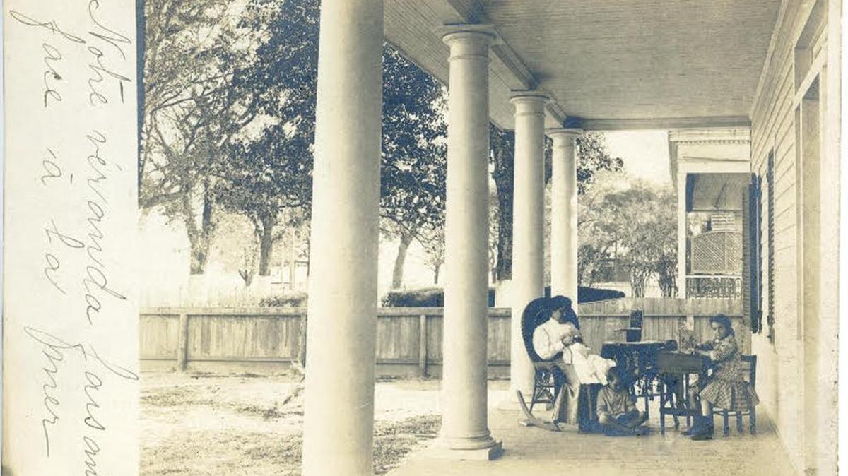 Julia Mallard and her children Louise and Albert enjoy comforts of the veranda of their Bay St. Louis home.