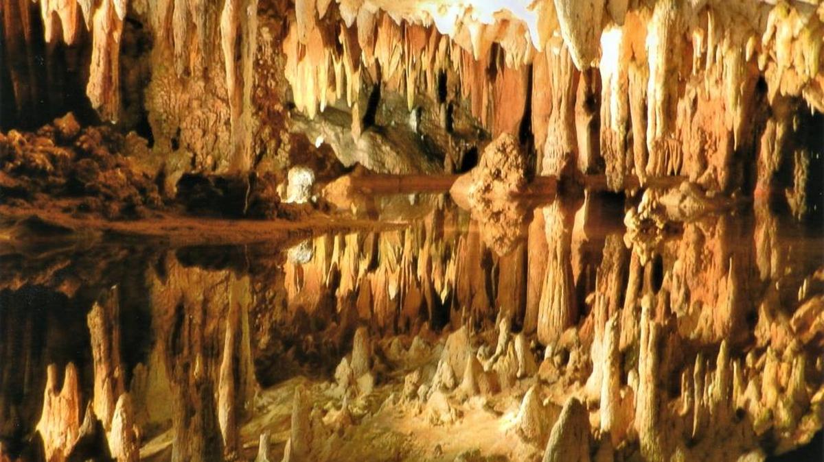 What looks like stalactites and stalagmites growing toward each other is an illusion. This is a shallow cave lake in Luray Caverns that reflects the stalactites growing from the ceiling of Luray Caverns in the Shenandoah Valley of Virginia.