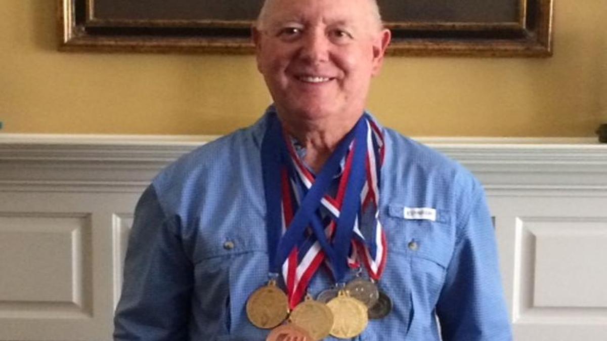 David Kernion displays his Senior Olympic powerlifting gold medals.