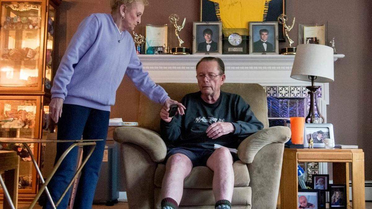 Settled into his comfortable chair in the television room of his Broomall, Pensylvania, home, Philadelphia Inquirer sports columnist emeritus Bill Lyon is handed the TV remote by his wife of 52 years, Ethel, for a few hours of soap operas and game shows on May 17, 2016. Lyon was diagnosed with Alzheimer’s disease three years ago and continues to lead an active life.