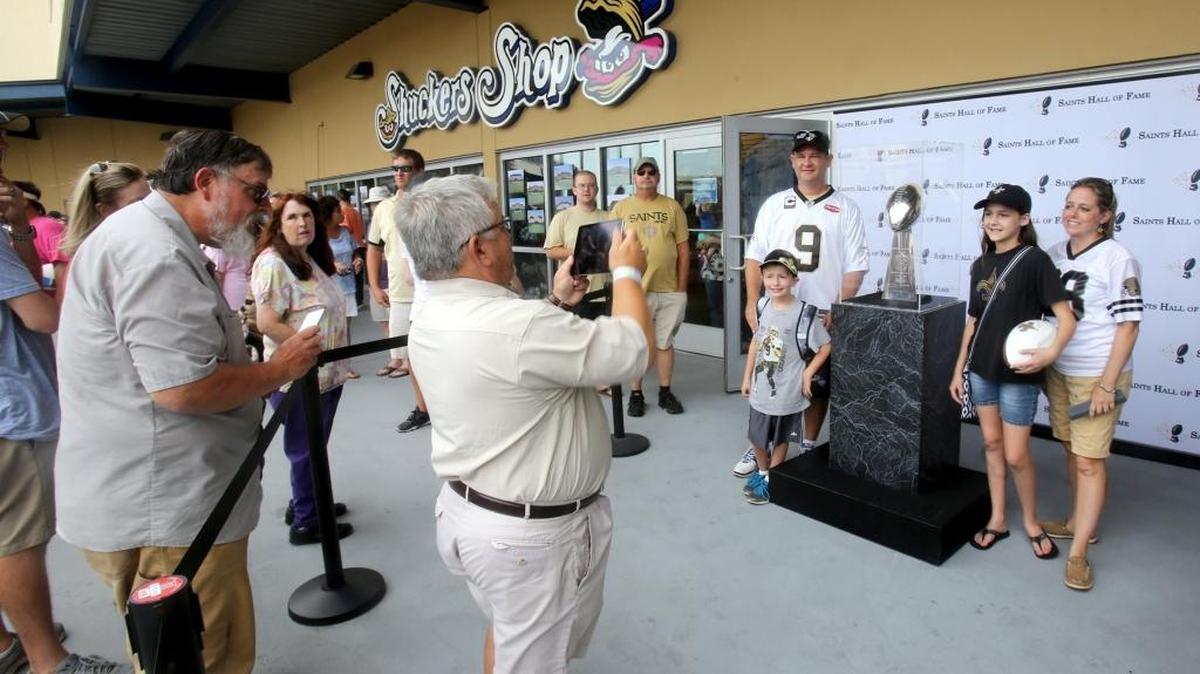 Saints fans take their photograph with the Vince Lombardi Trophy during a fundraiser at MGM Park on Saturday. Biloxi’s annual Saints Hall of Fame Day is Friday features a variety of events including a golf tournament, a free football clinic for kids and parents, and Saints Day with the Shuckers at MGM Park.
