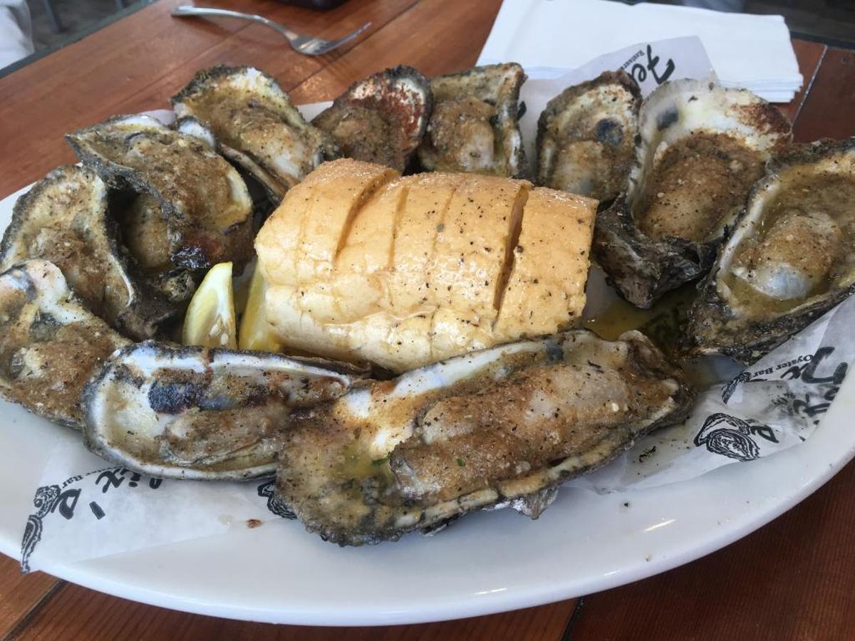 Char-Grilled Oysters at Felix’s Restaurant and Oyster Bar Gulfport are served with fresh bread.