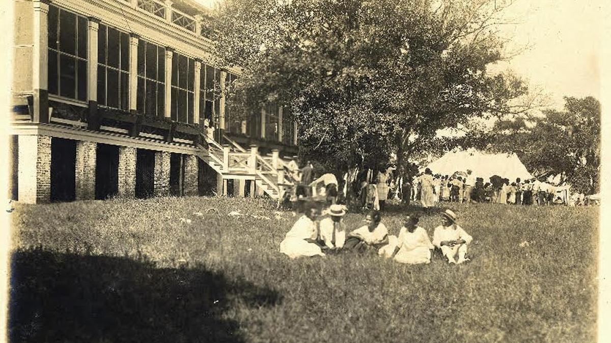 The old Jackson/Deblieux House is the scene of an open-air event in circa 1930.