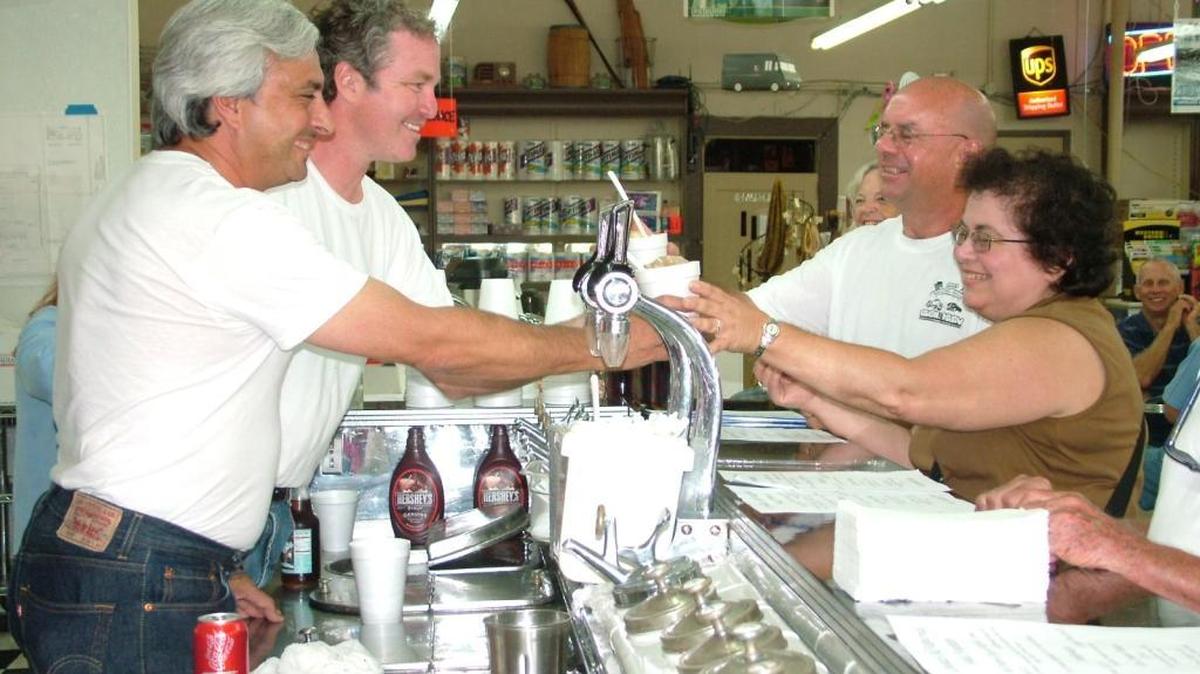 Soda fountain owners Paul Clark and Clark Levi serve up floats at Lovelace Drugs in Ocean Springs.