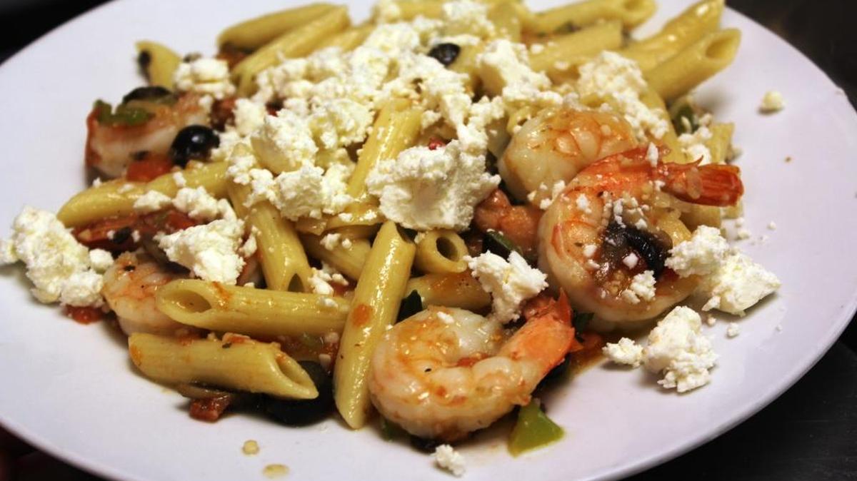 To the cooked pasta and sautéed shrimp add black olives, sauté red or green peppers, lots of good quality olive oil and as much goat cheese as you can stand.