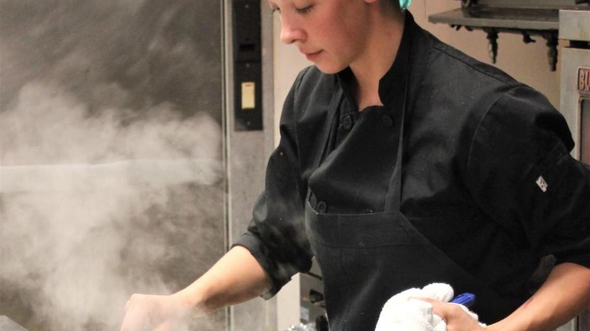 Chef Hillary Henley prepares clams at Corks and Cleaver Italian Bistro in Bay St Louis.