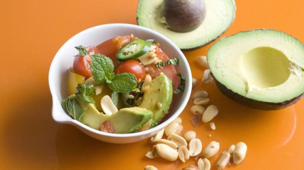 This June 2, 2014 photo shows tomato and avacado salad with gingered tomato vinaigrette and toasted peanuts.