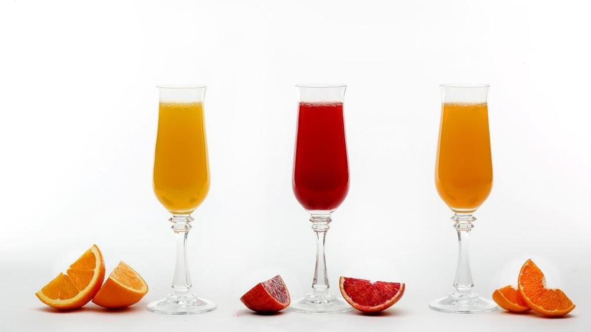 A mimosa made with orange juice, left, a mimosa made with blood orange juice, center, and a mimosa made with tangerine juice.