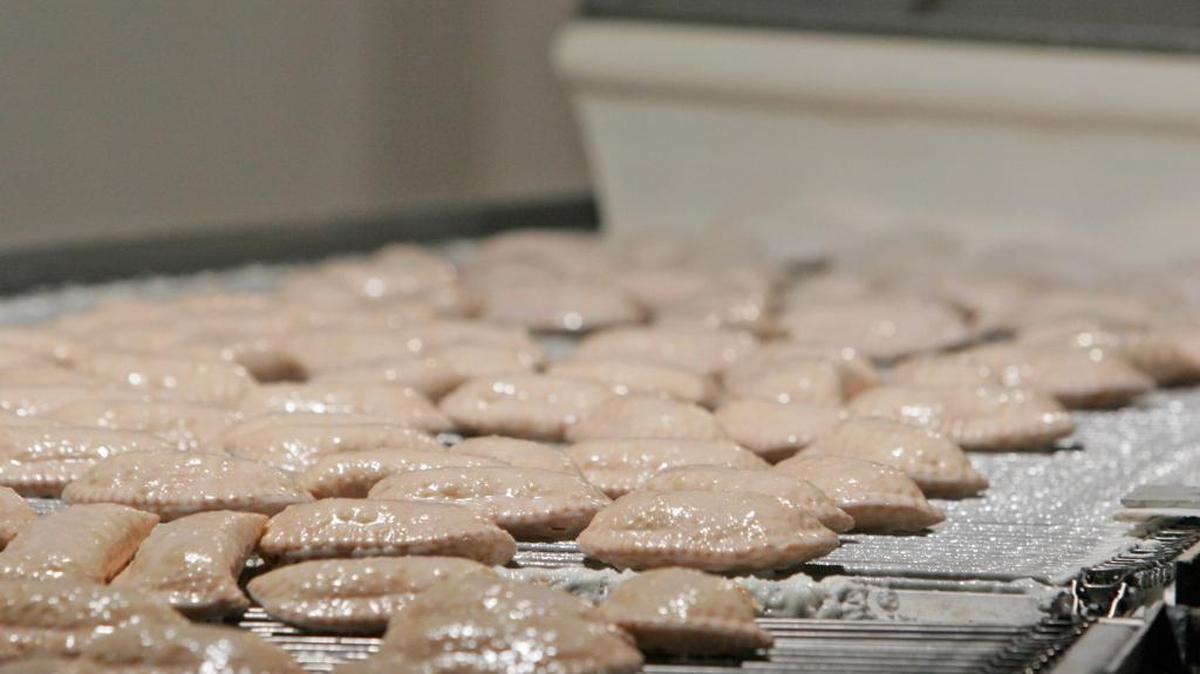 Freshly fried and covered with icing, pies move along the conveyor at Hubig’s Pies in New Orleans Tuesday, Feb. 27, 2007.
