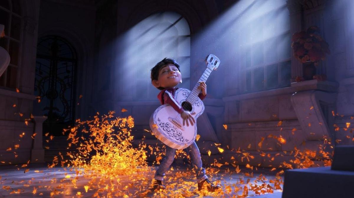 This image released by Disney-Pixar shows characters Miguel, voiced by Anthony Gonzalez in a scene from the animated film, ‘Coco.’