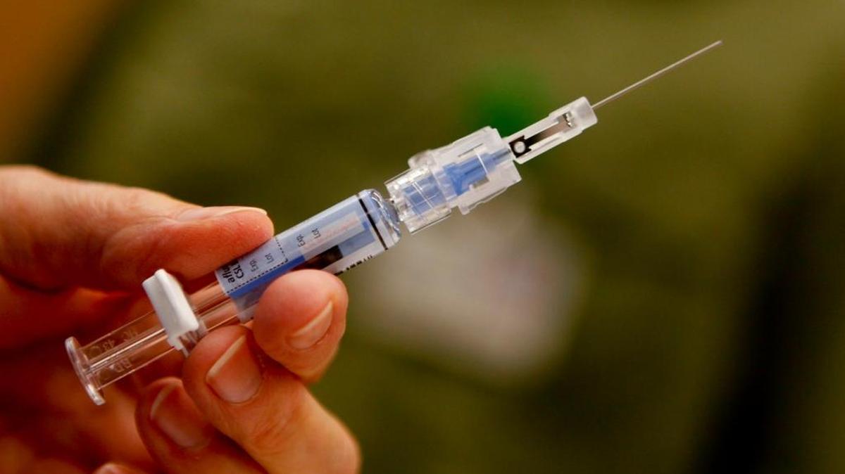 Downey (Calif.) Regional Medical Center RN Connie Meinke holds a syringe filled with the flu vaccine.