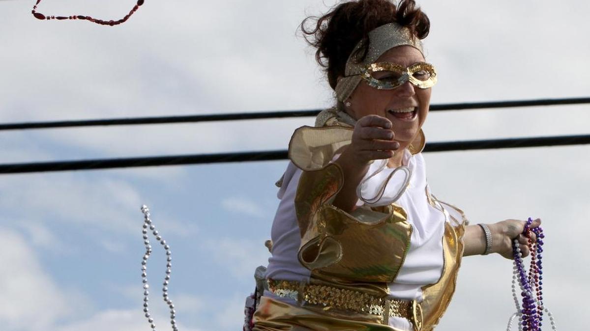 A float rider tosses throws during the Krewe of Nereids Mardi Gras parade in Waveland on Sunday Jan. 31, 2016.