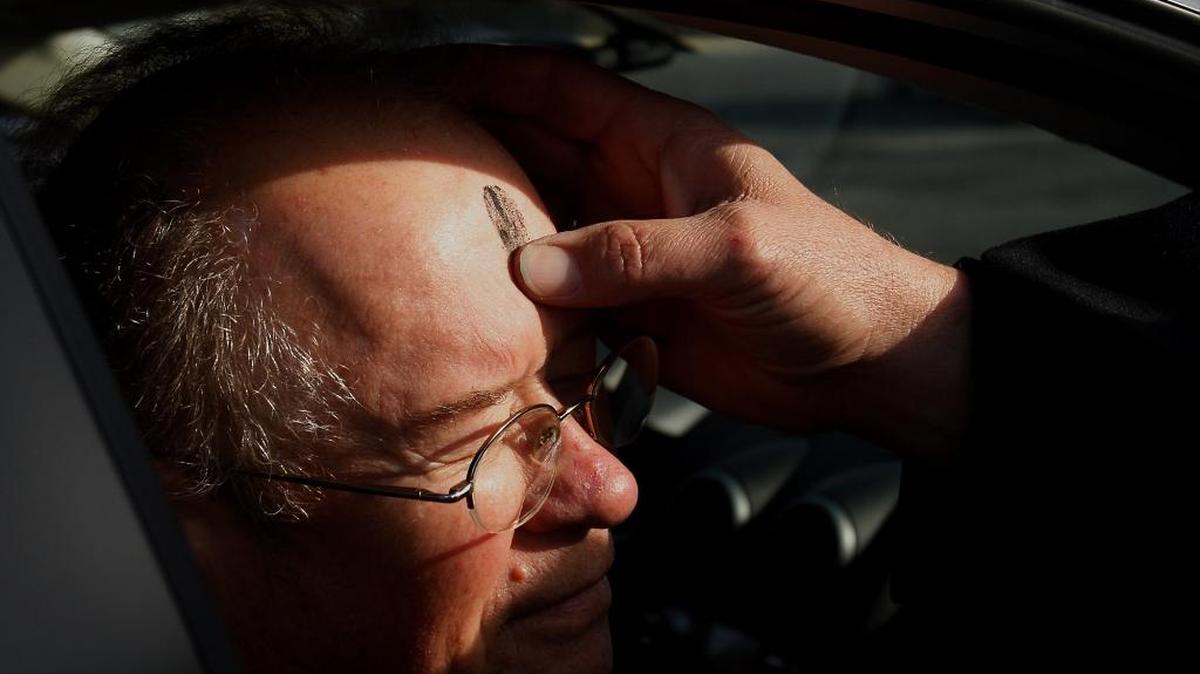 The Rev. Rod Dickson-Rishel of First United Methodist Church in Long Beach administers ashes to Paul Brosslett Jr. as he sits in a vehicle in March 2014. Those who need ashes on Ash Wednesday can get their blessing and mark “to go” in front Hancock Bank in downtown Gulfport from 7:30 a.m. to 9:30 a.m. on Wednesday, Feb. 14.