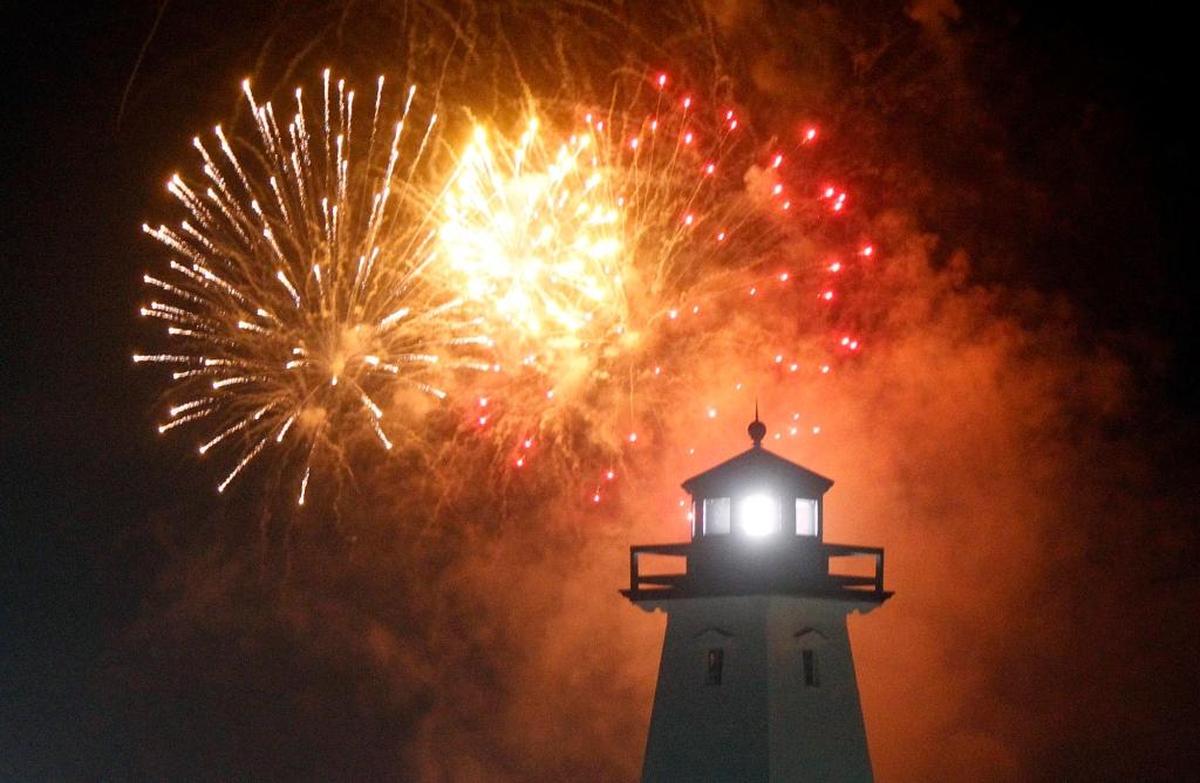 Fourth of July fireworks illuminate the sky behind the lighthouse at Jones Park in Gulfport. Fireworks shows are planned across the Coast over the long holiday weekend.