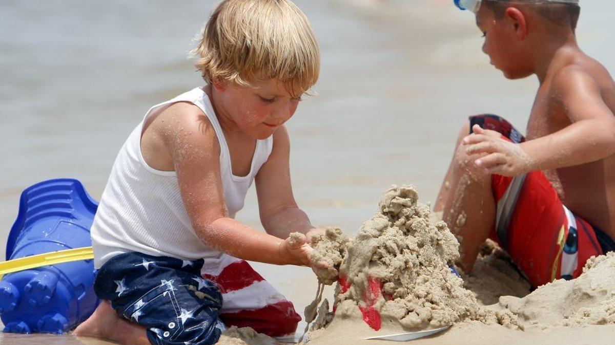 Kids build a sand castle while enjoying a day at the Biloxi beach, which has been named by U.S. News & World Report as the fifth best family beach destination in the country.