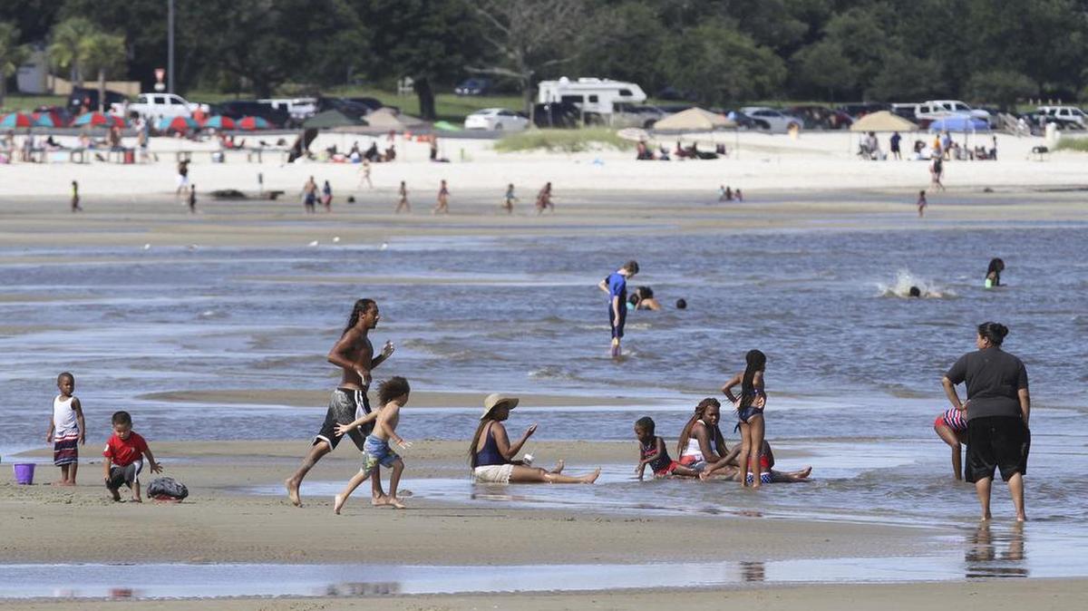 People enjoy the beach in Gulfport on Tuesday.