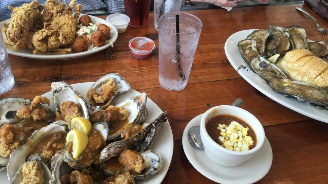 Diners at Felix’s Restaurant and Oyster Bar Gulfport are about to enjoy, clockwise from right, Char-Grilled Oysters, Turtle Soup, Oysters Du Jour and the Soft Shell Crab Platter.