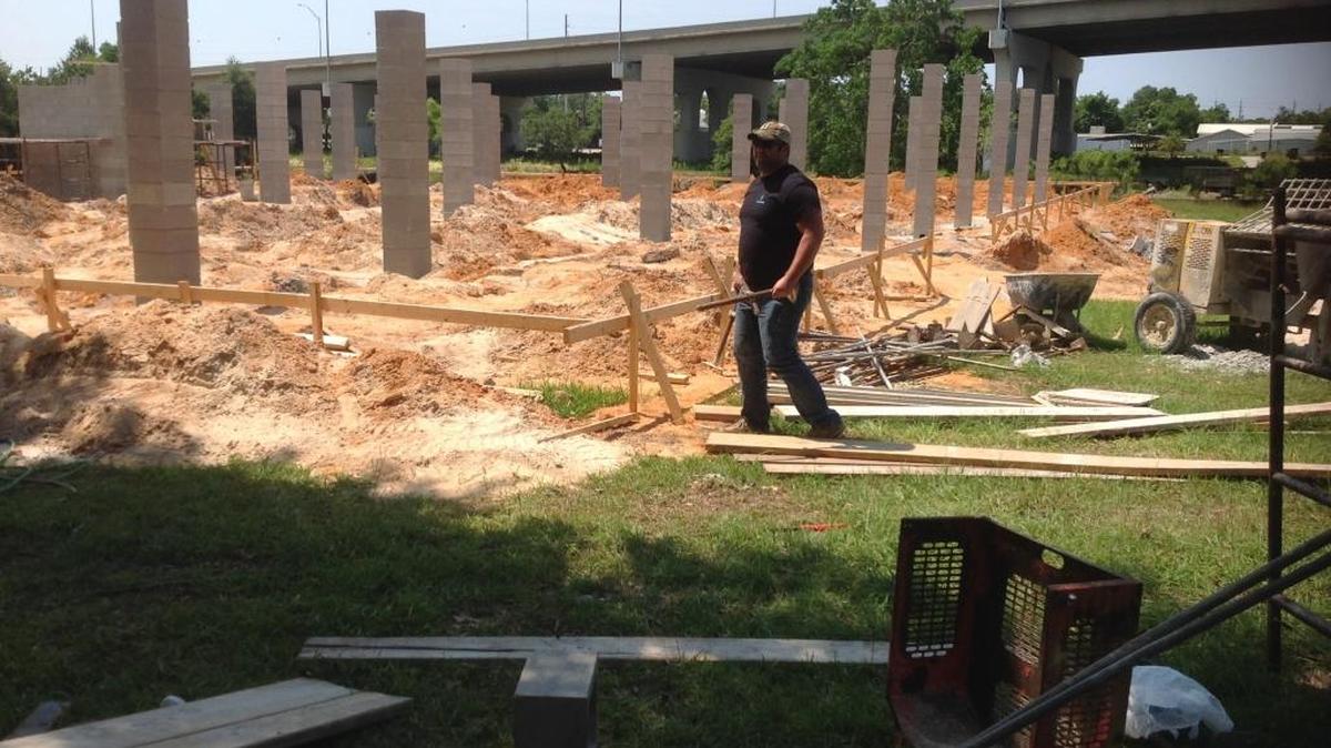 Tim Smith, with KT Construction, works at the site of a new seafood and steak restaurant coming to Magnolia Street, along the river, just north of U.S. 90 in the Lake Avenue area of the Pascagoula.